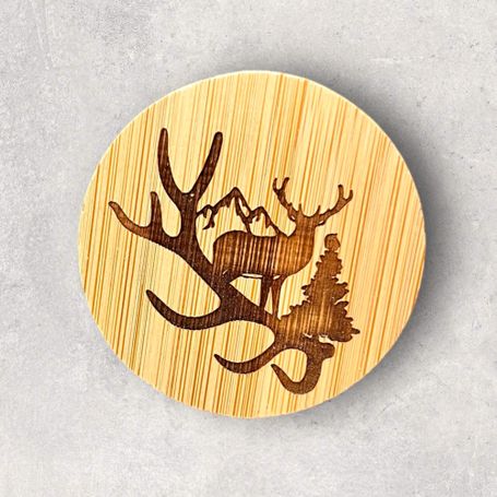 Magnetic round bamboo bottle opener featuring an engraved antler, buck, tree and mountain design
